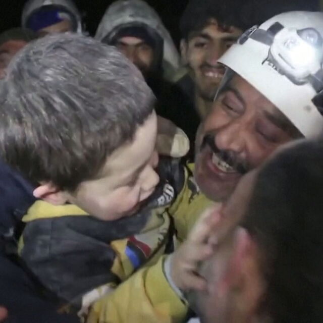 Сирийско момче си играе със спасителите, след като го извадиха от развалините